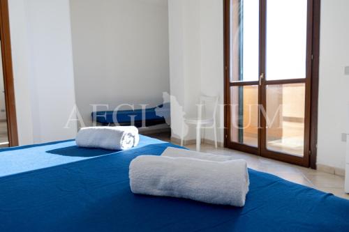two towels sitting on two beds in a room at Castello 9 in Isola del Giglio