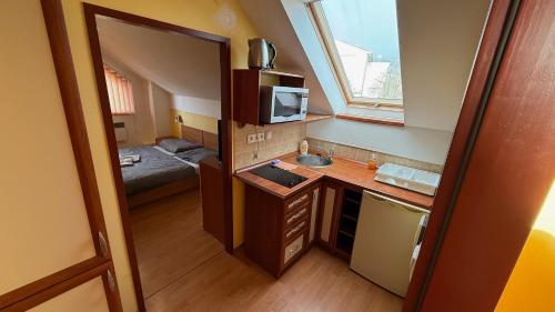 a small room with a kitchen and a bedroom at 2 room apartment, Hriadky, Liptovsky Mikulas in Liptovský Mikuláš
