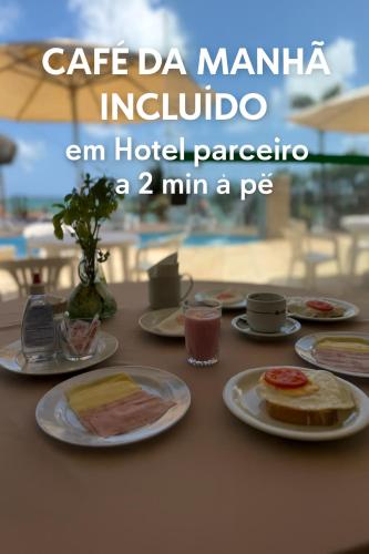 a table with plates of food on top of it at Residence Dunas in Natal
