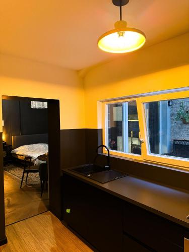 a kitchen with a sink and a window at Sān home’s in Antwerp