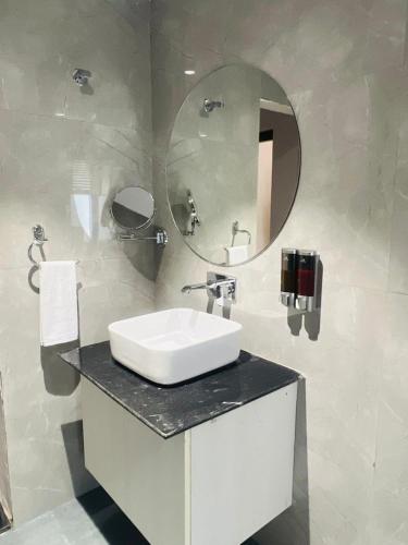 a bathroom with a sink and a mirror at Hotel Supreme Inn in Varanasi