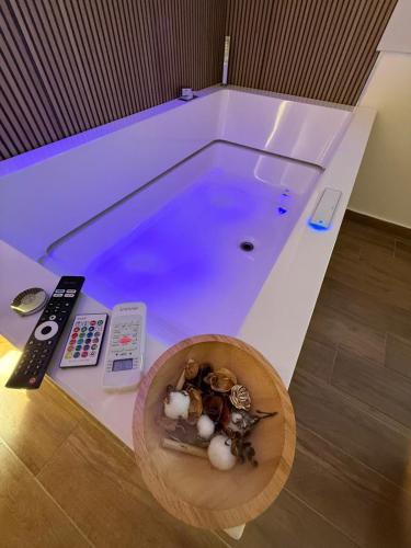 a swimming pool with a bowl of mushrooms and a remote control at Hotel Movida in Casoria