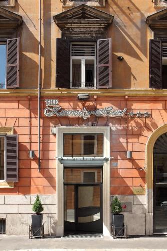 a building with two chairs in front of it at Hotel Kennedy in Rome