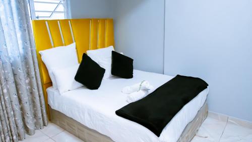 a bedroom with a bed with black and white pillows at DC Guest House in Avondale