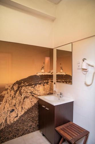 a bathroom with a sink and a mirror at WOT Sarrazola Soul in Sintra