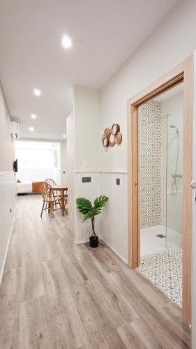 a bathroom with a shower and a potted plant at Apartamentos FLORIDA in Valladolid
