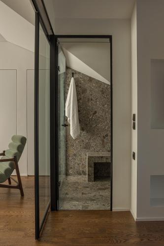 a glass door in a room with a fireplace at The Lake Loft in Ioannina