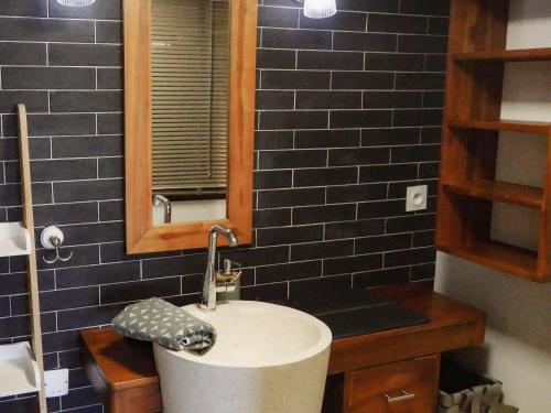 a bathroom with a sink and a mirror at VillaCarros - Studios in Sea & Mountain Villa near Nice with Idyllic View in Carros