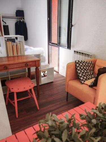 a living room with a couch and a table at VillaCarros - Studios in Sea & Mountain Villa near Nice with Idyllic View in Carros