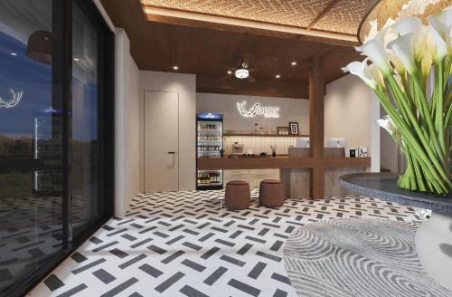 a lobby with a vase of flowers and a counter at Bohol panglao Diver's home resort in Panglao