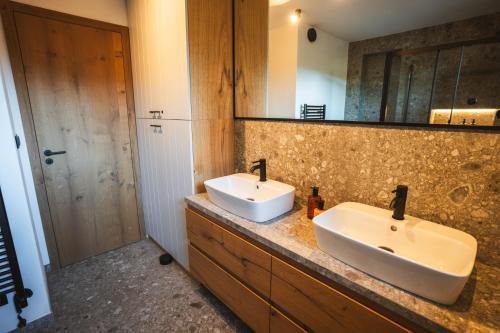 a bathroom with two sinks and a large mirror at Chalet Paseka in Pec pod Sněžkou