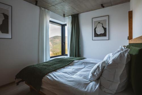 a bedroom with a bed with a large window at Chalet Paseka in Pec pod Sněžkou