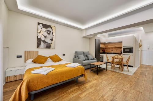 a bedroom with a bed and a living room at Apartamentos FLORIDA in Valladolid