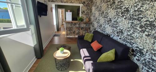 a living room with a couch and a table at L'Espadon in Luc-sur-Mer