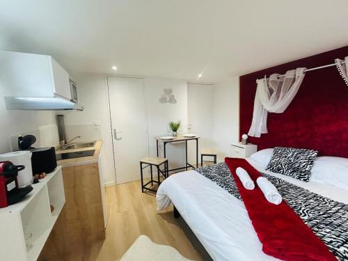 a bedroom with a large bed with a red headboard at Casa Rubis in Les Ponts-de-Cé