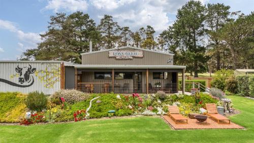 a building with a garden in front of it at Rosa Glen Retreat - Farm Stay, Margaret River in Rosa Glen
