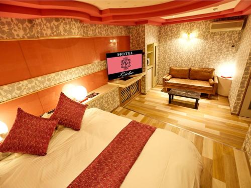 Postel nebo postele na pokoji v ubytování ホテル Liebe 岐阜