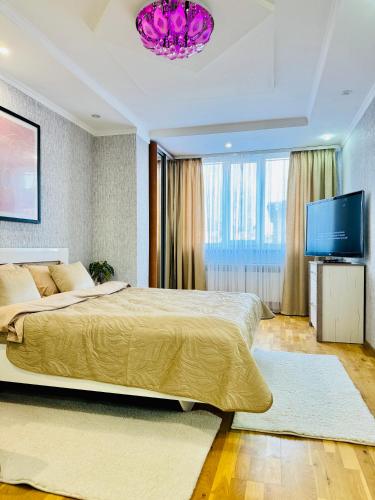 una camera da letto con un letto grande e una TV a schermo piatto di Центр. Хмельницького. 2 спальні a Ternopilʼ