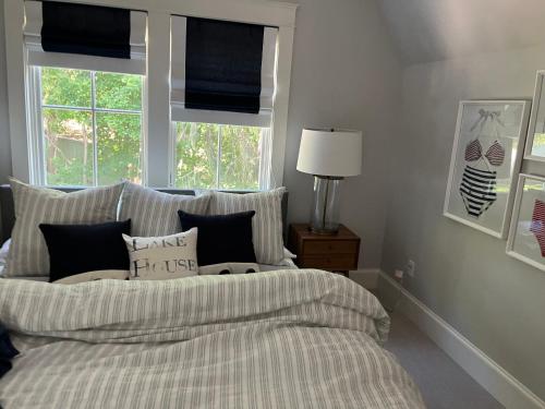 a bedroom with a bed with pillows and a window at Ivywild Boutique Cottage in Broadmoor