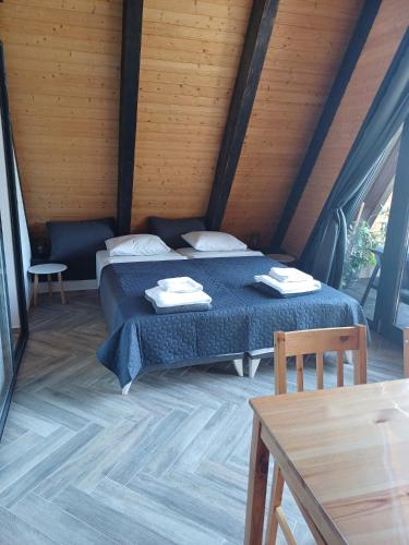 a bedroom with two beds and a wooden ceiling at A frame Alba Iulia in Alba Iulia