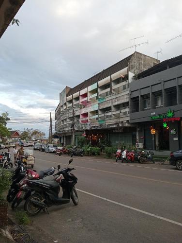 a group of motorcycles parked on the side of a street at italay in Krabi