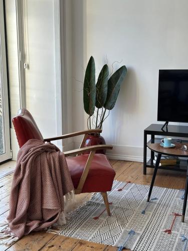 a living room with a chair and a potted plant at Belem1886 - Tagus Horizon in Lisbon