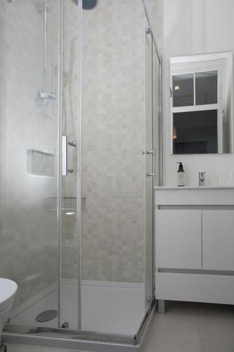 a bathroom with a shower and a toilet and a sink at Belem1886 - Tagus Horizon in Lisbon