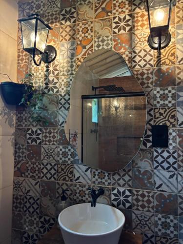 a bathroom with a sink and a mirror at Chácara do Conde in Mangaratiba