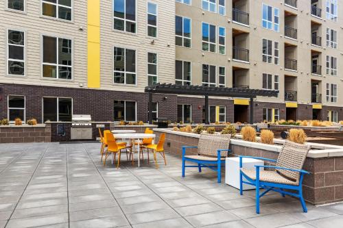 a patio with chairs and tables and a table and chairs at Kasa Rino Denver in Denver