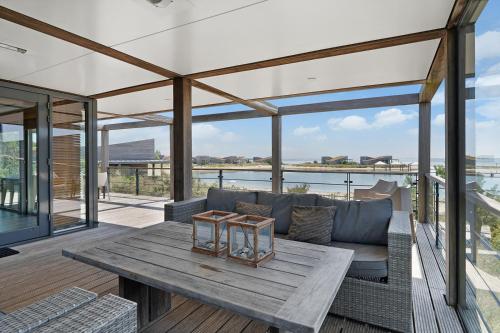a living room with a couch and a table at Beach Resort Punt West in Ouddorp