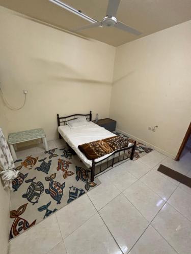 a bedroom with a bed in a room with a rug at AJMAN HOME Stay ONLY FOR COUPLES FAMILY AND LADIES in Ajman 