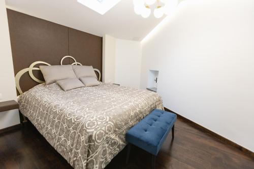a bedroom with a bed and a blue stool at Casa Matteo Piran in Piran