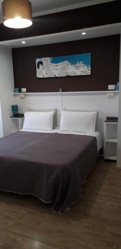 a bedroom with a large bed with two pillows at B&B I Tre Sensi in Crotone