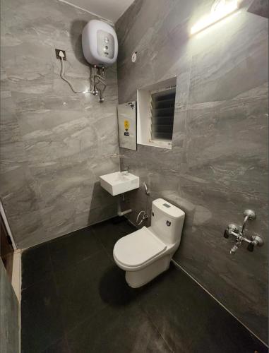a bathroom with a toilet and a sink at Coffee valley resort Yercaud CVR in Yercaud