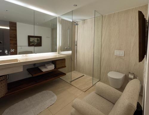 a bathroom with a sink and a toilet and a mirror at Apartment Chalet Ambros in Lech am Arlberg