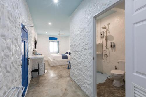 a bathroom with a shower and a toilet in a room at Sweett Lemon Home in Patong Beach