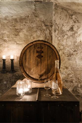 a bottle of wine and two glasses on a table at Kongsvinger Castle Hotel & Resort in Kongsvinger