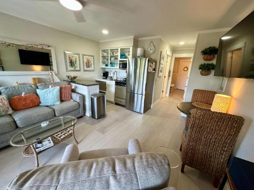 a living room with a couch and a kitchen at Seaside 382 in Hilton Head Island