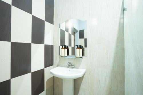 a bathroom with a sink and a mirror at Stamps By Eight Continents, Pushkar in Pushkar