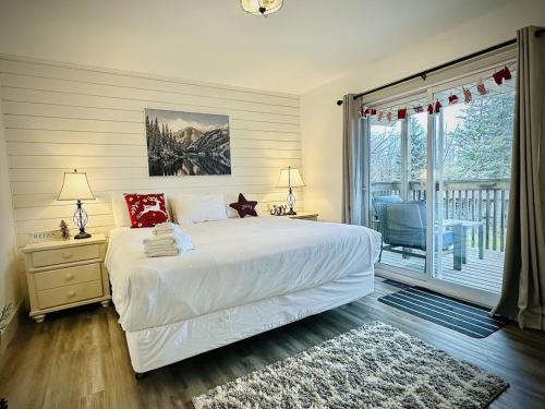 a bedroom with a white bed and a balcony at Pony Trail in Collingwood