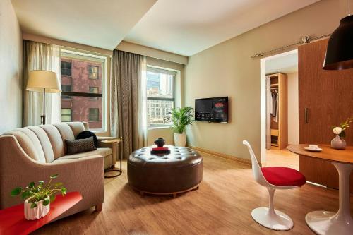 a living room with a couch and a table at Sports Illustrated Resorts Chicago in Chicago