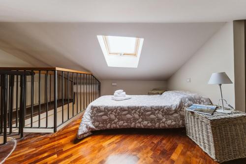 a bedroom with a bed and a skylight at Evi Suite in Santa Margherita Ligure