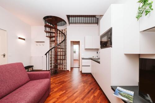 a living room with a red couch and a kitchen at Evi Suite in Santa Margherita Ligure