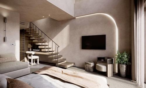 ein Wohnzimmer mit einer Couch und einem Fernseher an der Wand in der Unterkunft Aethra in Nydri