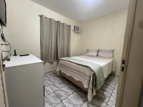 En eller flere senge i et værelse på Apartamento 2 quartos excelente localização