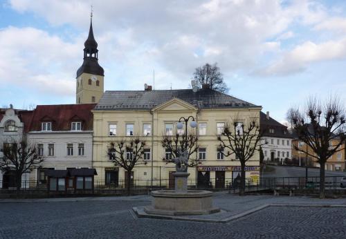 a large building with a clock tower on top of it at Penzion SKLAŘSKÁ HOSPODA in Chřibská