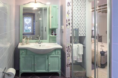 a bathroom with a green sink and a shower at Boutique Cardea in Split