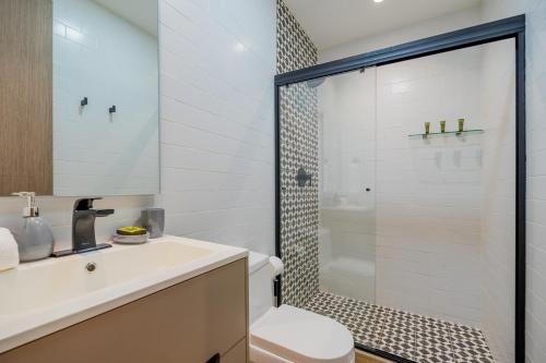 a bathroom with a shower and a toilet and a sink at La Cuadra - Casco Viejo in Panama City