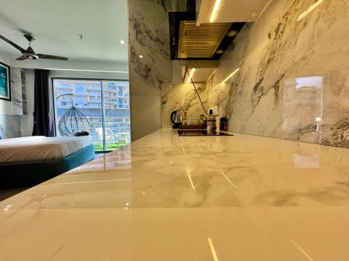 a room with a marble counter top and a bed at Mulberry Homes Supernova in Noida