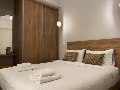 a bedroom with a large bed with towels on it at Abete Luxury Apartments in Metsovo